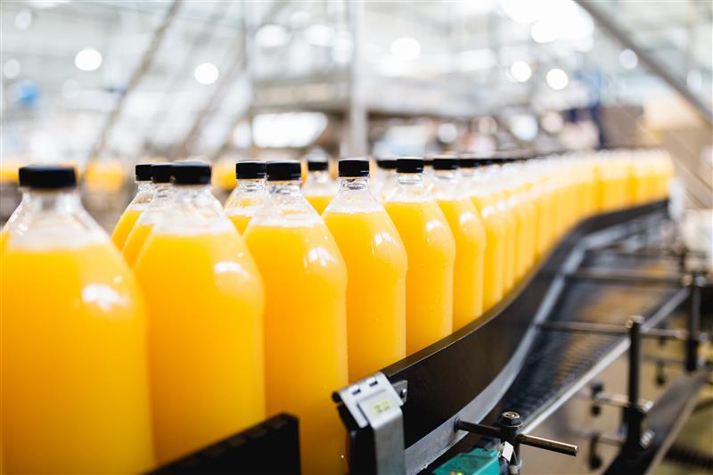 Orange juice bottles on a conveyor belt
